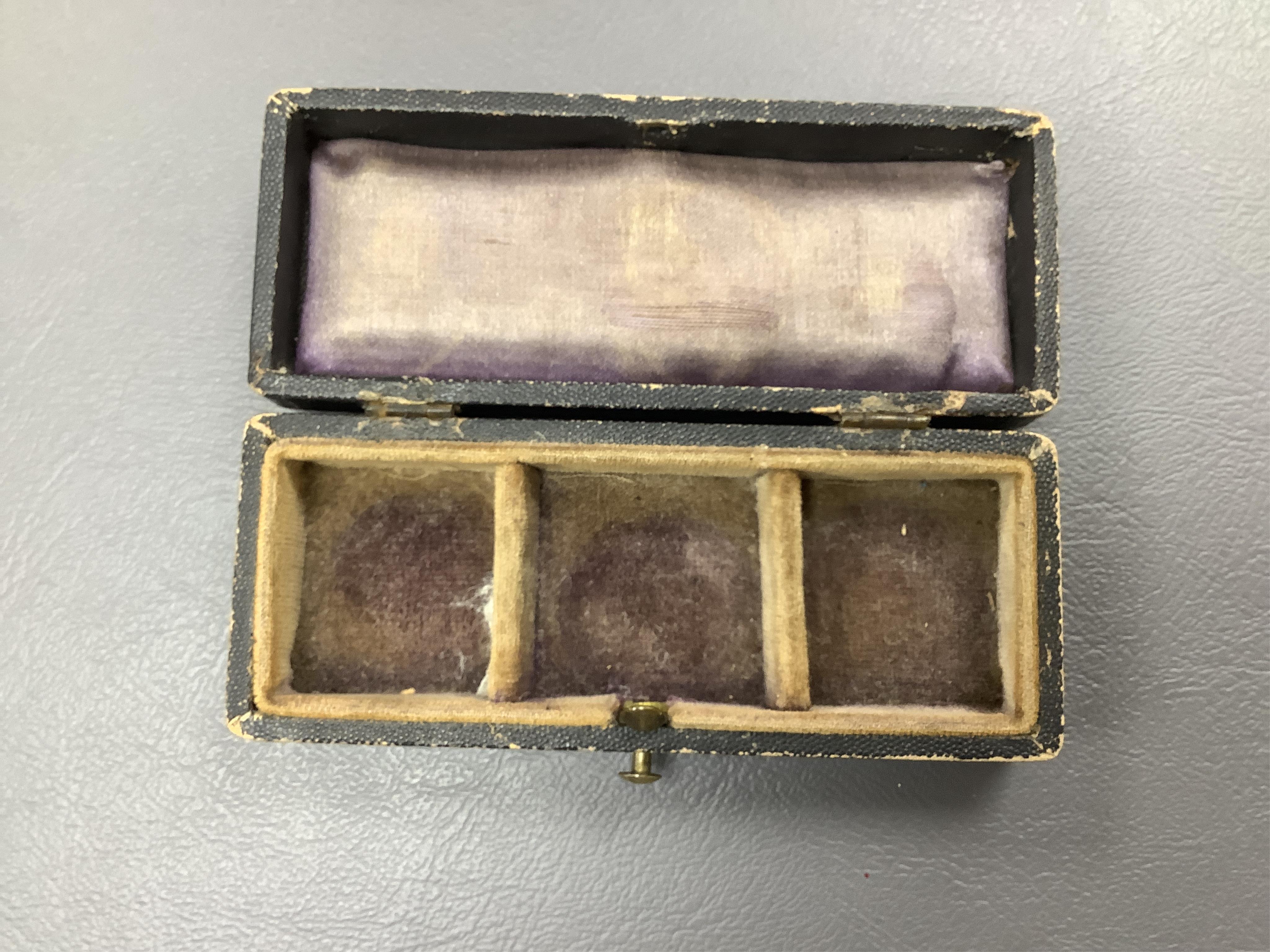 A late 19th century cased group of three prosthetic glass eyes
